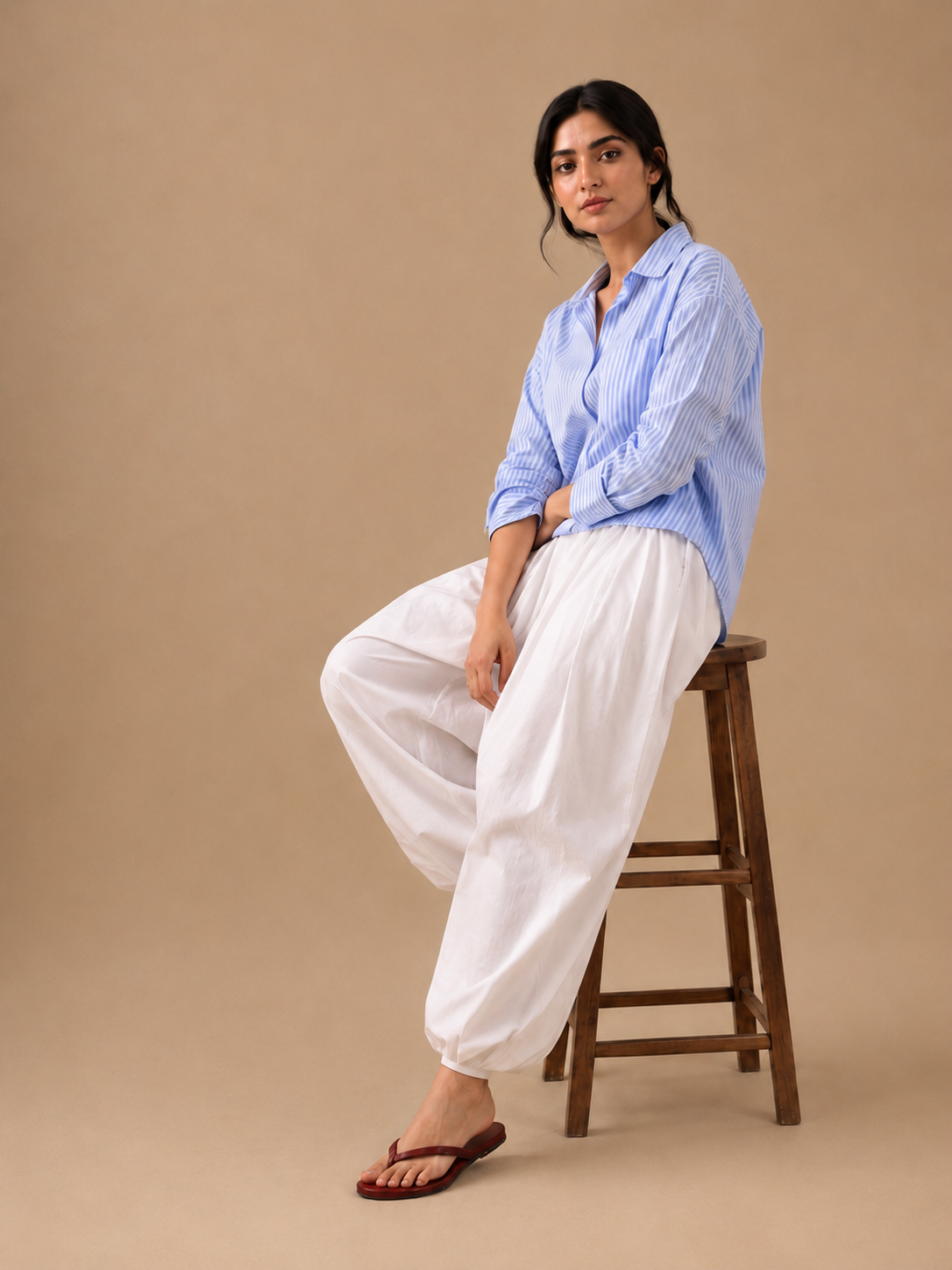 Blue stripe relaxed shirt with white balloon pajama, seated styling