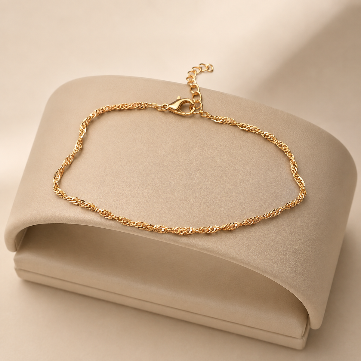 Gold rope chain anklet on a cream display stand