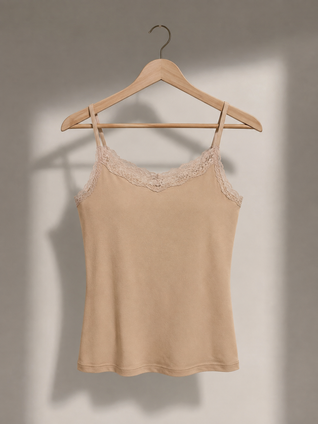 Nude lace camisole on wooden hanger