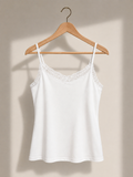 White lace camisole on wooden hanger