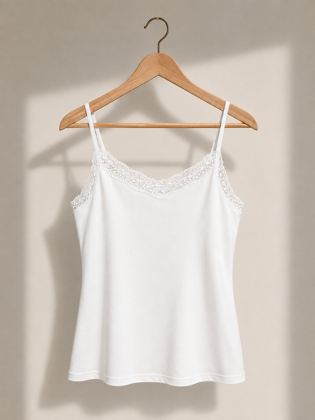 White lace camisole on wooden hanger