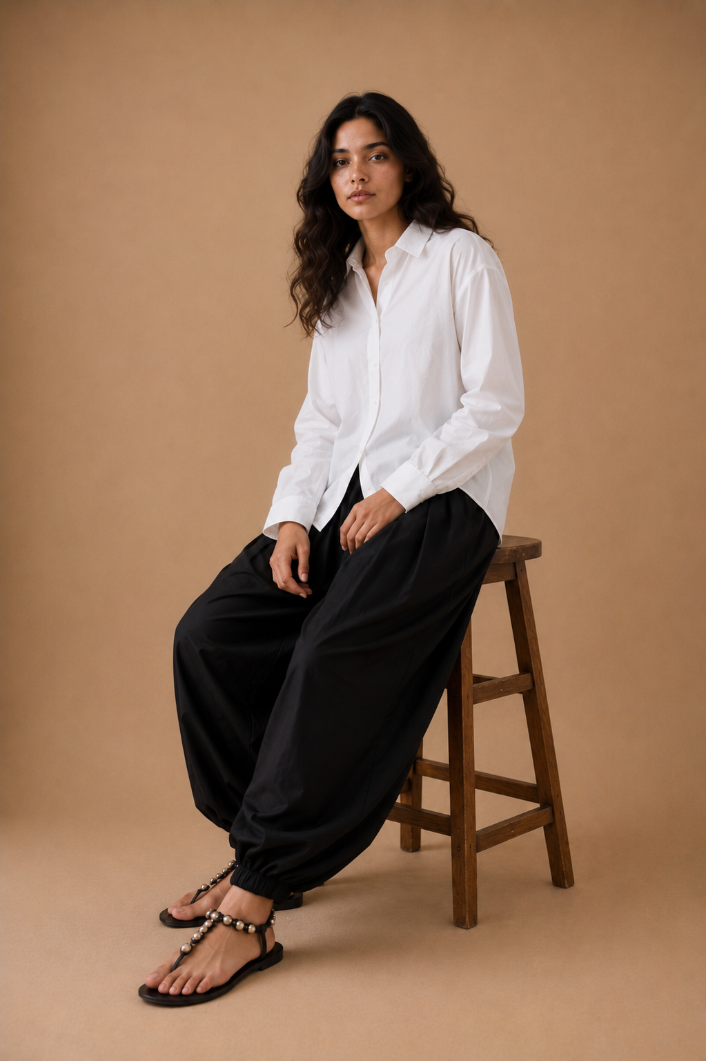 White relaxed shirt with black balloon pajama, seated styling